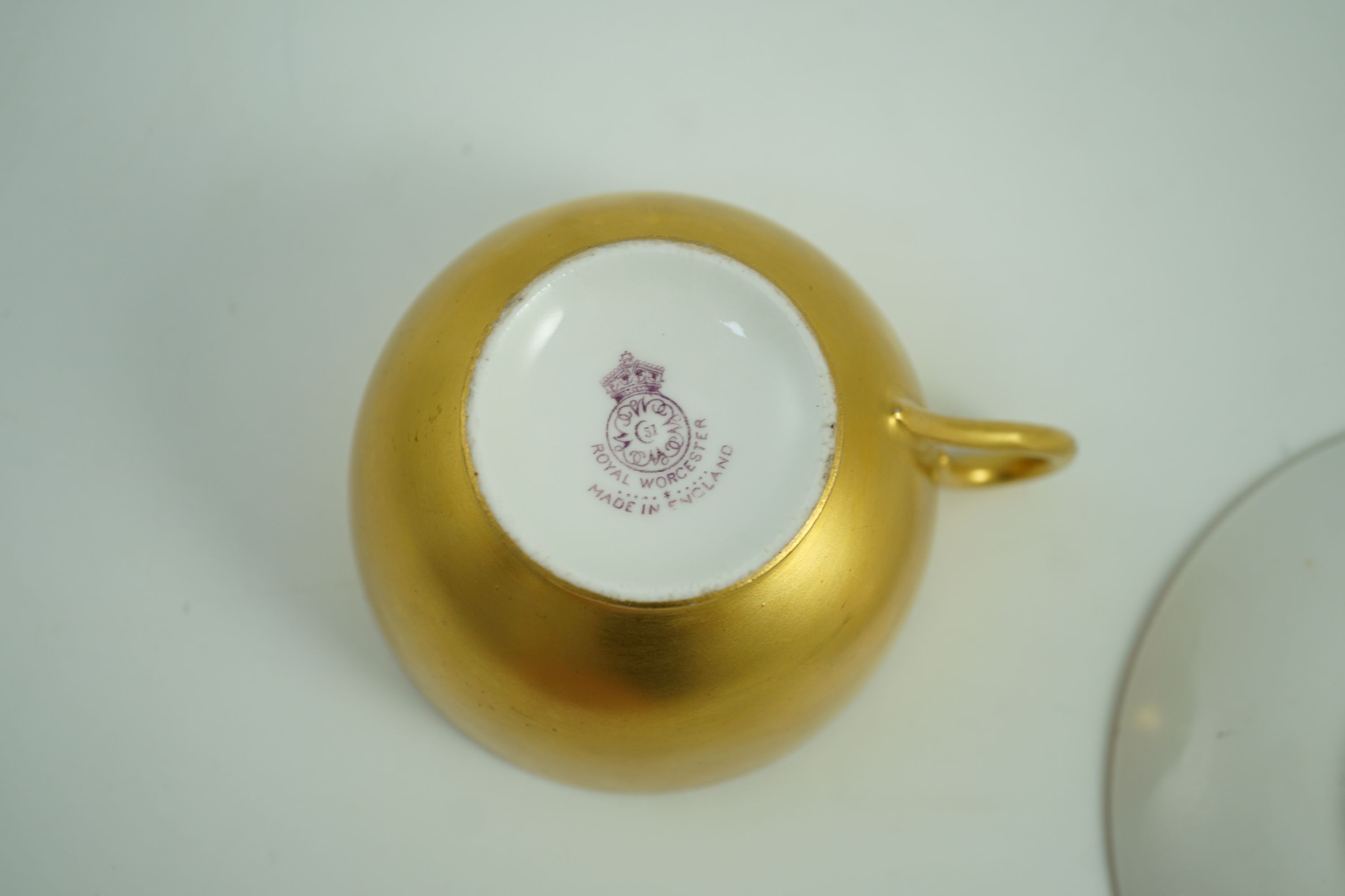 A Royal Worcester fruit painted tea cup and saucer, date code for 1925/6